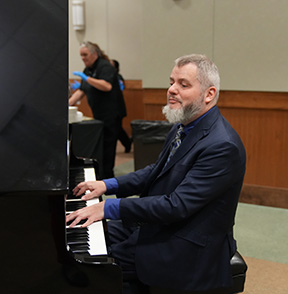 Chris Danielsen plays the piano for a gala event at NFB headquarters in Baltimore.